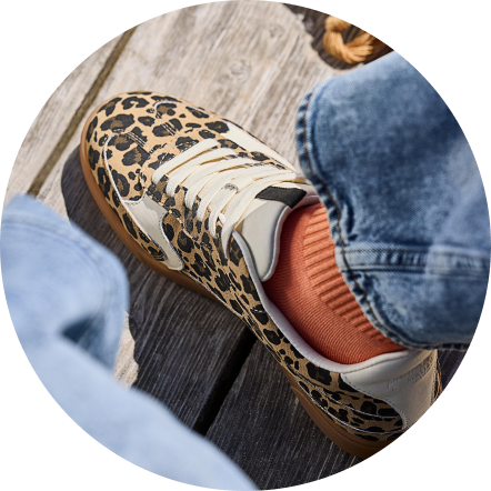 Casual sneakers styled on a bright background